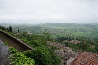 High angle view of green landscape against sky