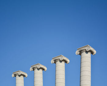 Low angle view of communications tower against clear blue sky
