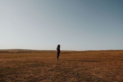 Full length of man on field against clear sky