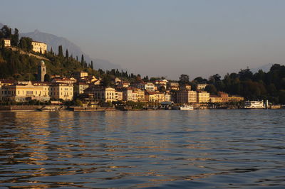 River by houses against clear sky