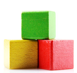 Close-up of multi colored wooden blocks against white background