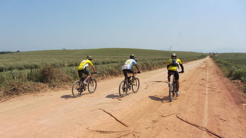 Man cycling on dirt road