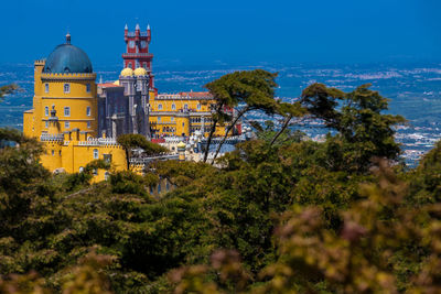 The pena palace seen from the gardens of pena park at the municipality of sintra