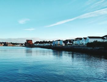 Calm blue sea with buildings in background