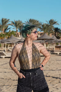 Side view of woman standing at beach