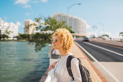 Portrait of woman standing against sky