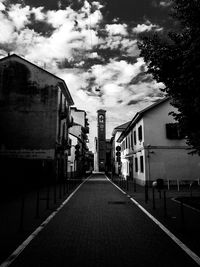 Empty narrow road along buildings