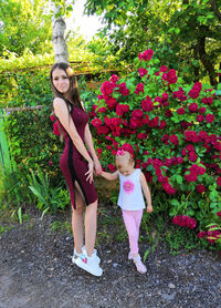 Full length of woman with pink flowering plants