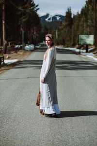 Portrait of woman standing on road