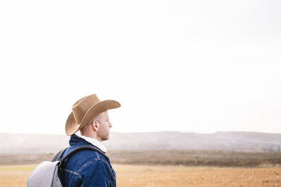 Man in hat looking at view