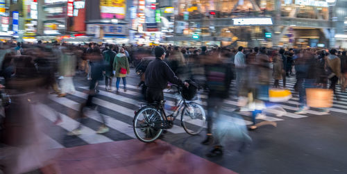 Blurred motion of people on illuminated city