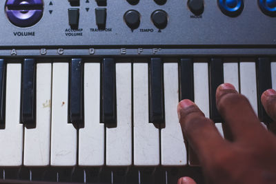 Midsection of person playing piano