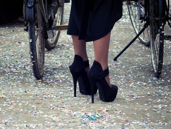 Low section of woman in black high heels