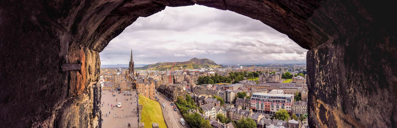 Panoramic view of buildings in town against sky