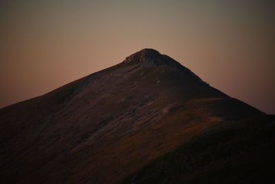 Low angle view of mountain against sky during sunset