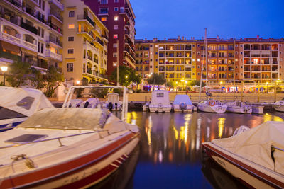 Boats in canal with buildings in background