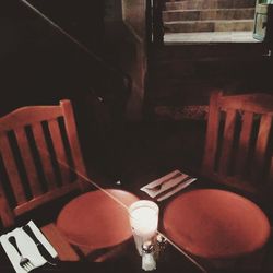 High angle view of empty chair on table