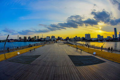 City at waterfront during sunset