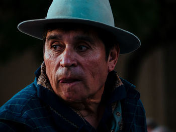 Close-up portrait of senior man wearing hat