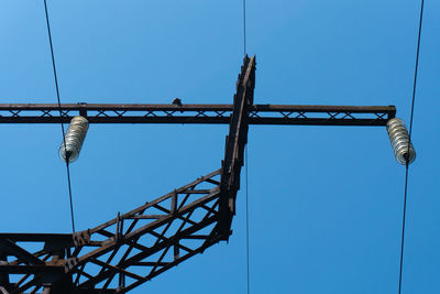 Low angle view of metallic structure against clear blue sky