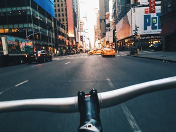 Cropped image of bicycle moving on city street