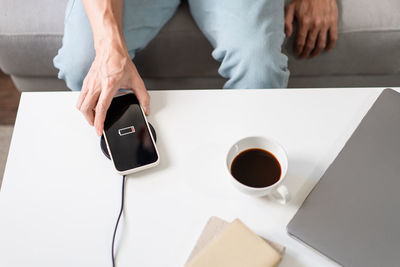 Midsection of woman using mobile phone