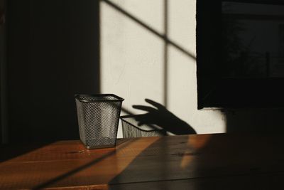 Shadow of person on table against wall
