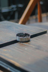 Close-up of cigarette ashtray on table