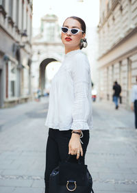 Portrait of a young woman on city street