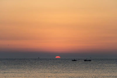 Scenic view of sea against sky at sunset