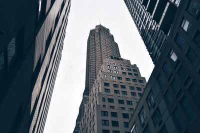 Low angle view of empire state building in city against sky