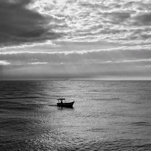 Boat sailing on sea against sky