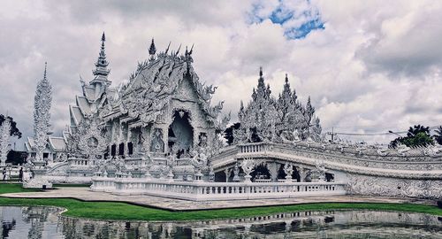 Statue of temple against cloudy sky