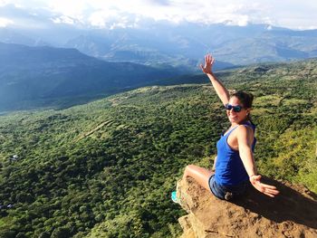 Woman on rock against mountains