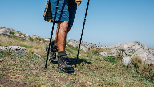 Unrecognizable senior man practicing trekking outdoors