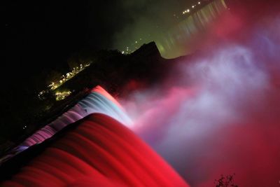 Low angle view of illuminated light against sky at night