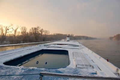 Scenic view of snow covered trees against sky during sunset