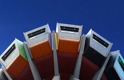 Low angle view of boats against clear blue sky