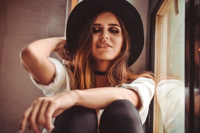 Portrait of young woman sitting outdoors