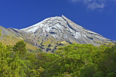 Scenic view of mountains against blue sky