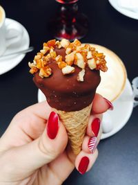 Close-up of hand holding ice cream cone in hand