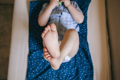 Directly above shot of boy lying on bed at home