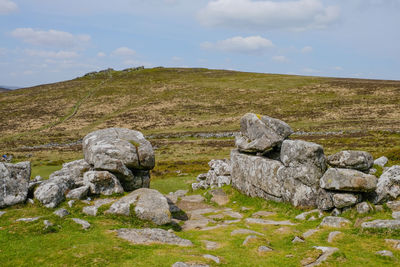 Rocks on landscape against sky