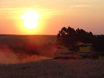 Scenic view of field against sky during sunset