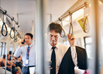 Man holding camera in bus