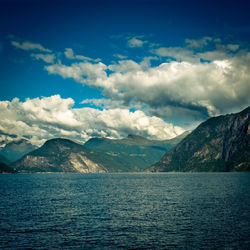 View of calm sea against mountain range