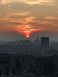 High angle view of buildings against sky during sunset