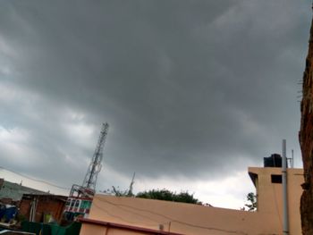 High section of houses against cloudy sky