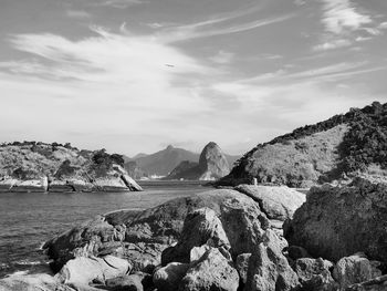 Scenic view of sea and mountains against sky