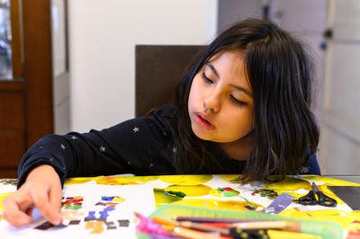 Young woman painting at home